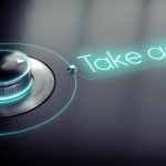 Neon Sign Reads Take Action! Next To Dial on Black Background