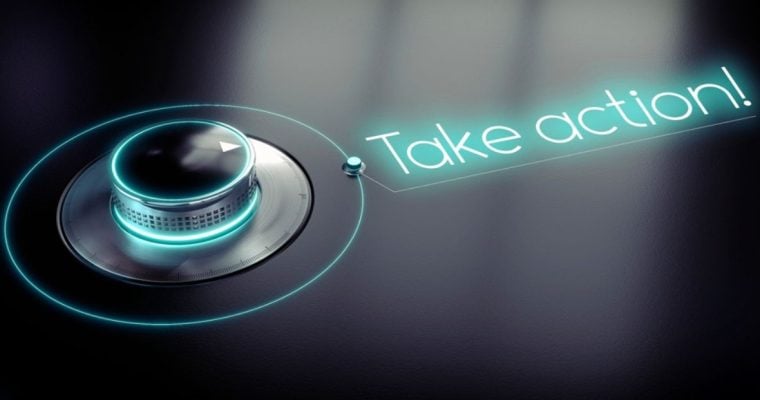 Neon Sign Reads Take Action! Next To Dial on Black Background