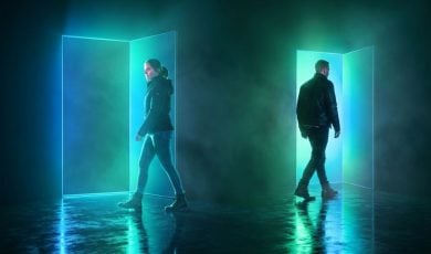 Bright Blue/Green Doors in Dark Room with Two People Going Opposite Directions