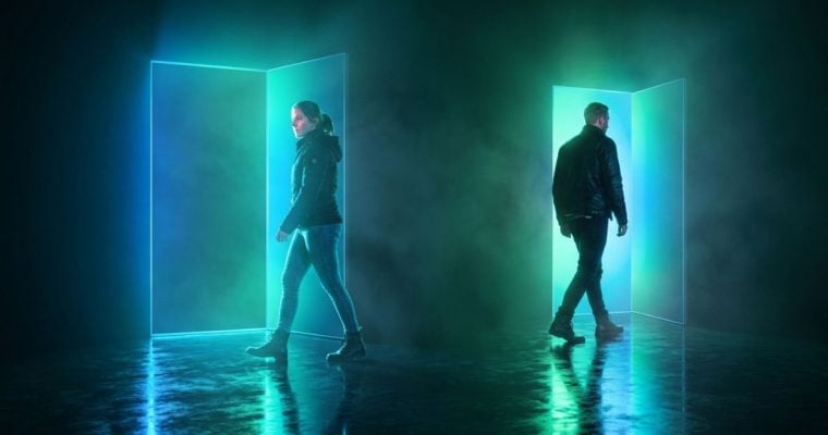 Bright Blue/Green Doors in Dark Room with Two People Going Opposite Directions