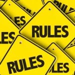Small Yellow Square-Shaped Signs Read Rules in a Pile