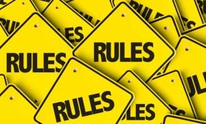 Small Yellow Square-Shaped Signs Read Rules in a Pile