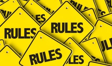 Small Yellow Square-Shaped Signs Read Rules in a Pile