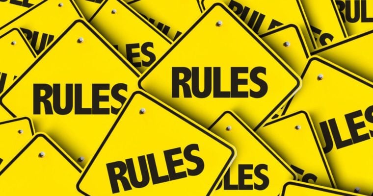 Small Yellow Square-Shaped Signs Read Rules in a Pile