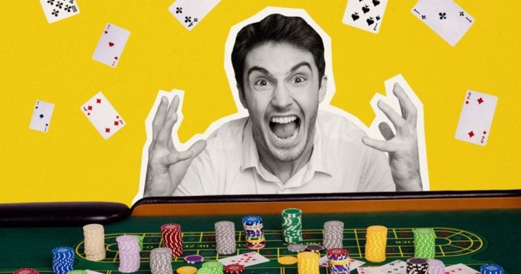 Man Sits In Front of Stacked Poker Chips with Excited Expression