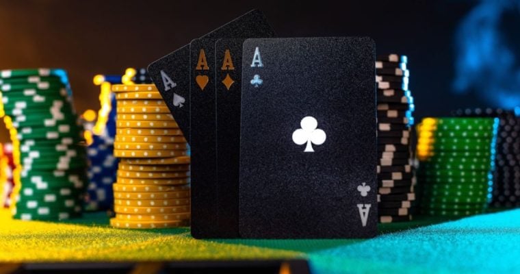 4 Aces Stand On Green Game Table Surrounded By Stacks of Poker Chips