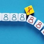 Scissors Icon Separates Small White Blocks with Human-Shaped Figures in Blue and Red
