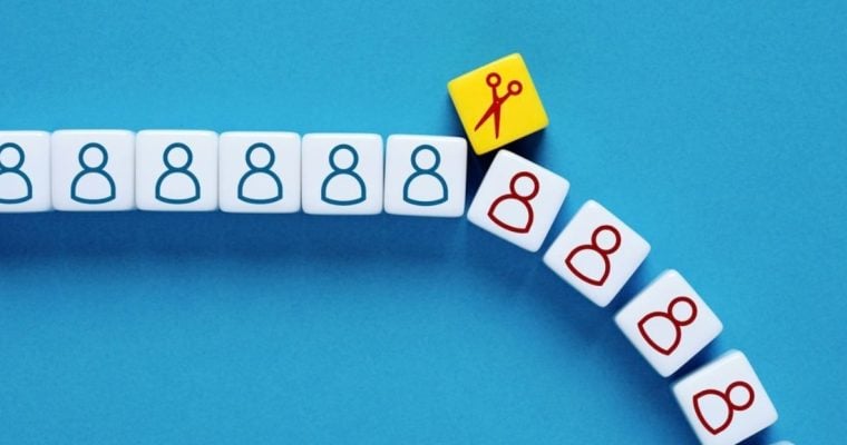 Scissors Icon Separates Small White Blocks with Human-Shaped Figures in Blue and Red
