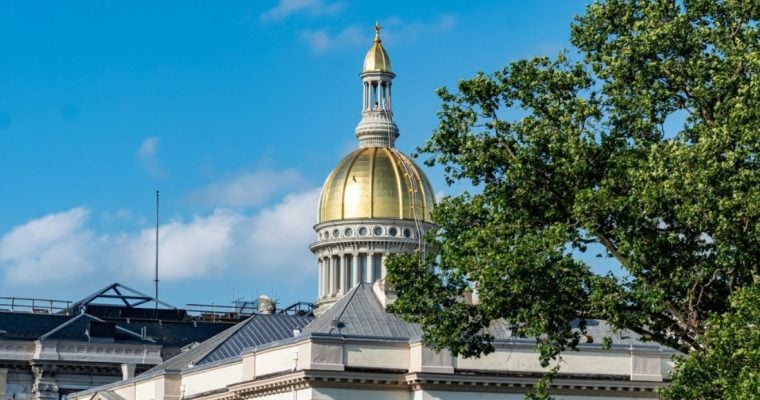 Blue Skies and Green Tree Top Surround Gold Dome at the Capitol Building in New Jersey