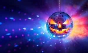 Scary Pumpkin Face Disco Ball Shines Orange and Blue Lights on Dark Wall