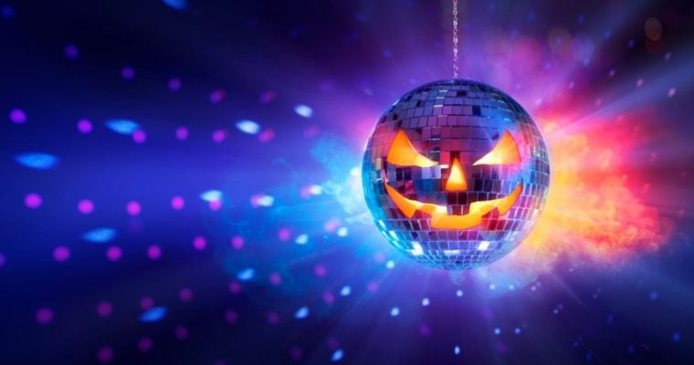 Scary Pumpkin Face Disco Ball Shines Orange and Blue Lights on Dark Wall