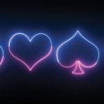 Club, Heart, Spade and Diamond Shape in Neon on Black Background