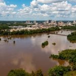 Flooded Brown Pearl River with Jackson, Mississippi Cityscape in the Background