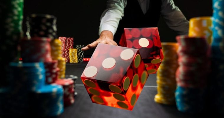 Two Red Dice Flying Over Game Table Lined With Colorful Money Chips