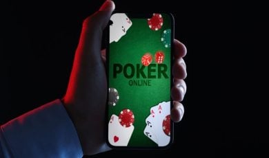 Online Poker App Displayed on Smartphone Held in Man's Hand