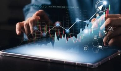 Complex Upward Trending Data Graph Overlays Image of Man Using Tablet on Table