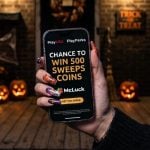 Woman with Halloween Nails Holds Cell Phone With McLuck's New PlayPerks Offer