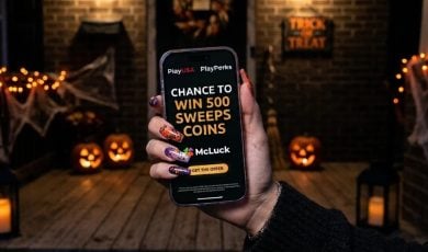 Woman with Halloween Nails Holds Cell Phone With McLuck's New PlayPerks Offer