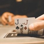 Man Has Spade and Diamonds of Jack Playing Cards For Poker Hand
