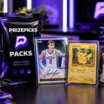Cell Phone Stands Next To PrizePicks Pack and Valuable Collectible Cards