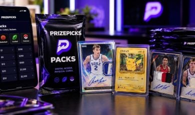 Cell Phone Stands Next To PrizePicks Pack and Valuable Collectible Cards
