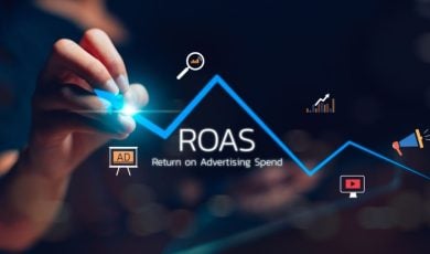 Hand Draws Rising Blue Line with Icons Related to Marketing and ROAS Text